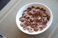 Breakfast Chocolate Cornflakes Cereal with milk in white bowl