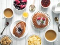 Breakfast chocolate pancakes with berries, a Cup of coffee with cream, honey and cereals. Top view