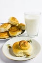 Breakfast with cinnamon buns and glass of milk on a white background. Royalty Free Stock Photo