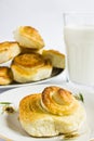 Breakfast with cinnamon buns and glass of milk on a white background. Royalty Free Stock Photo