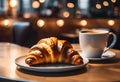 breakfast with coffee and croissant, restaurant and bokeh