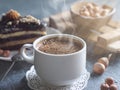 Breakfast. Coffee morning , with a slice of cake and hazelnuts on a textural background