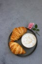 Breakfast with coffee mug, fresh croissants and pink rose on grey stone background. Beautiful composition. Coffee concept. Top Royalty Free Stock Photo