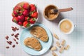 Breakfast with coffee and sandwiches with peanut paste and strawberries Royalty Free Stock Photo