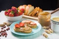 Breakfast with coffee and sandwiches with peanut paste and strawberries Royalty Free Stock Photo