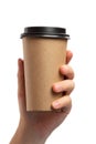 Breakfast and coffee theme: man`s hand holding empty paper coffee cup with a brown plastic cap isolated on a white background in Royalty Free Stock Photo