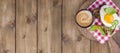 Breakfast with coffee, toasts, butter and jam on wooden background. Banner