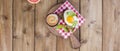 Breakfast with coffee, toasts, butter and jam on wooden background. Banner