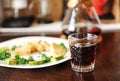 Breakfast with coffee. Trendy old fashioned crystal glass. Japanese omelet with avocado and greens on white plate. Manual