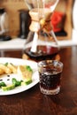 Breakfast with coffee. Trendy old fashioned crystal glass. Japanese omelet with avocado and greens on white plate. Manual