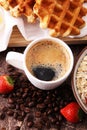 Breakfast with coffee and waffle, strawberries on brown wooden b