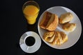 Breakfast. Coffee white cup, plate with bread on dark table Royalty Free Stock Photo