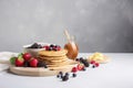 Breakfast composition with fresh pancakes and berries created with Generative AI technology Royalty Free Stock Photo