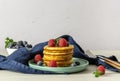 Breakfast concept with american pancakes with raspberries, mint, and blueberries