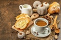 Breakfast concept with a cup of coffee, croissants, milk jug, and decorative crochet pumpkins Royalty Free Stock Photo