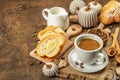 Breakfast concept with a cup of coffee, croissants, milk jug, and decorative crochet pumpkins Royalty Free Stock Photo