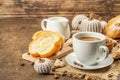 Breakfast concept with a cup of coffee, croissants, milk jug, and decorative crochet pumpkins Royalty Free Stock Photo