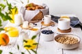 Breakfast concept with cup of coffee, croissants, wholegrain hoops, milk, orange juice, yogurt and blueberries Royalty Free Stock Photo