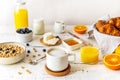 Breakfast concept with cup of coffee, croissants, wholegrain hoops, milk, orange juice, yogurt and blueberries Royalty Free Stock Photo