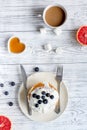 Breakfast concept with flowers on wooden background top view Royalty Free Stock Photo