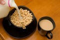 Breakfast consisting of cereal with milk and coffee with cream Royalty Free Stock Photo