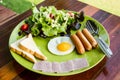 Breakfast consists eeg,salad,bread,bacon and sausage Royalty Free Stock Photo