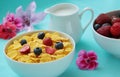 Breakfast. Corn flakes, milk and fresh fruits as blueberries and strawberries on blue background. Close up view. Royalty Free Stock Photo