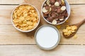 Breakfast Cornflakes and various cereals in bowl and milk cup on wooden background for cereal healthy food