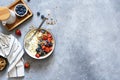 Breakfast - cottage cheese with berries and a cup of coffee, top view. Granola with nuts, honey and strawberries