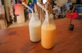 Breakfast of a couple with tasty sweet fruit smoothies, in small bottles on the table of cafe. Concept of healthy dates