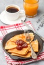 Breakfast. Crepes. Thin pancakes with strawberry jam