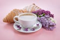 Breakfast with croissant and coffee. Branch lilac