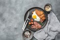 Breakfast croissant sandwich with fried egg and bacon, microgreens, coffee. Top view, flat lay, copy space. Royalty Free Stock Photo