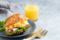 Breakfast croissant sandwich with ham and scrambled eggs Royalty Free Stock Photo