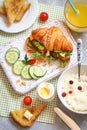 Breakfast with croissant sandwich, rice, Casas berries, boiled e