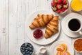 Breakfast with croissants, coffee, jams and berries Royalty Free Stock Photo