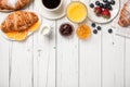 Breakfast with croissants, coffee, orange juice, fruits and berries Royalty Free Stock Photo