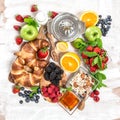 Breakfast with croissants, muesli, fresh berries, fruits. Health