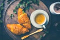 Breakfast - Croissants with nuts and cup of coffee on morning table Royalty Free Stock Photo