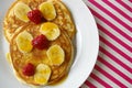 Breakfast crumpets with banana and raspberry Royalty Free Stock Photo