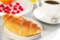 Breakfast. A cup of coffee and croissant Royalty Free Stock Photo