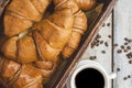 Breakfast with cup of coffee and fresh croissant. Flat lay. Top view. Homemade croissant with black coffee or americano Royalty Free Stock Photo