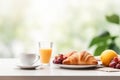 Breakfast with cup of coffee, fresh croissants and orange juice on white table, blurred nature background Royalty Free Stock Photo