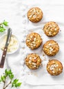 Breakfast dairy free muffins. Whole grain mini muffins with dried apricots, oatmeal, apple, carrots and nuts on light background