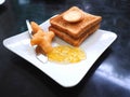 Breakfast with deep-fried dough stick or Patongko with Sweetened condensed milk and toast with marmalade jam Royalty Free Stock Photo