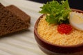 Breakfast with dish from soft-boiled egg with red caviar, served with bread Royalty Free Stock Photo