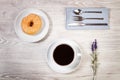 Breakfast with donut and american coffe on a white wooden table