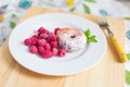 Breakfast. Donut with raspberries on plate