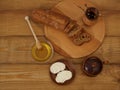 Breakfast in earthenware with natural honey, toast with curd cheese and french baguette on a wooden table