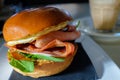 Breakfast egg and bacon roll with coffee in the background Royalty Free Stock Photo